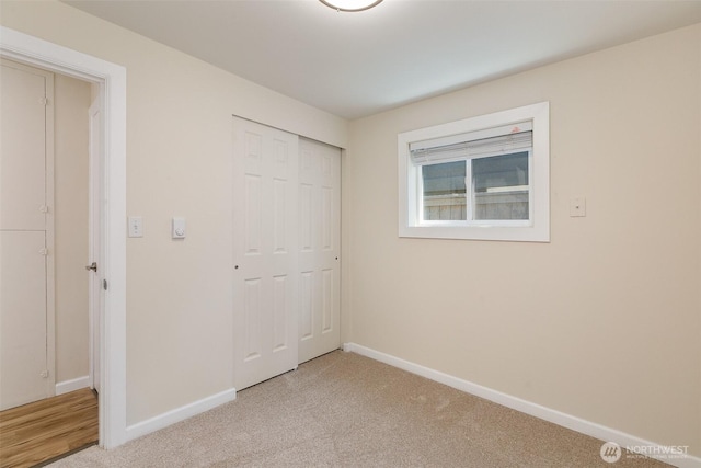 3513 NE 7th Pl, Renton, WA 98056 - unfurnished bedroom with a closet, baseboards, and light carpet