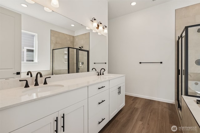 5941 Thornhill Ave SW Unit 291, Port Orchard, WA 98367 - bathroom with double vanity, a shower stall, wood finished floors, and recessed lighting