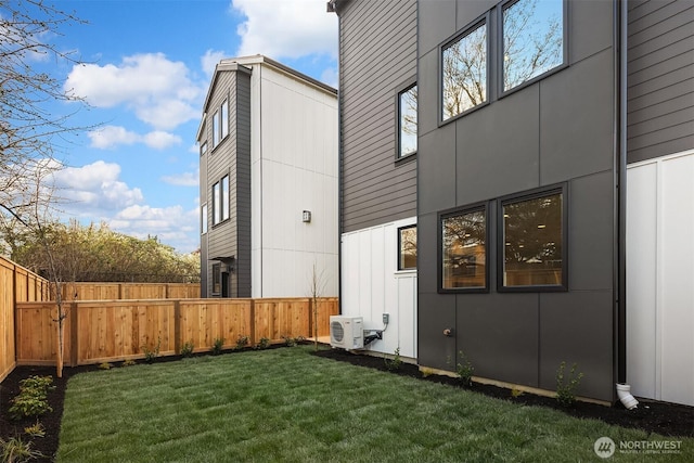 view of home's exterior with ac unit, fence, and a yard
