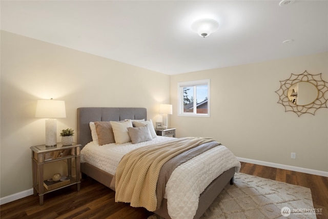 bedroom featuring baseboards and wood finished floors