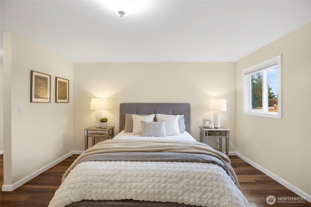 bedroom featuring dark wood-type flooring and baseboards