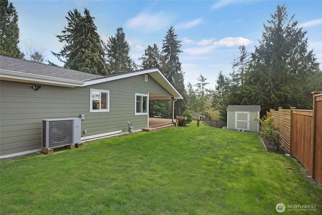 view of yard with central air condition unit, a shed, a fenced backyard, and an outdoor structure