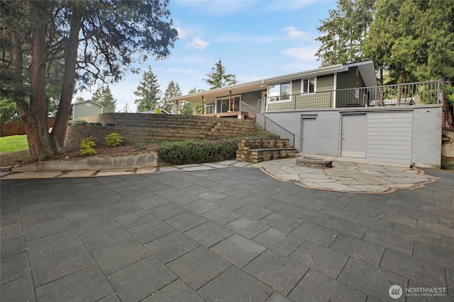 view of patio / terrace with stairs, fence, and a fire pit