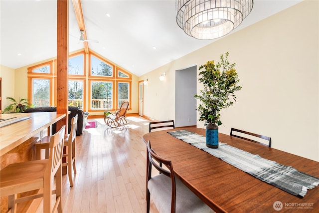 324 Gill Ln, Friday Harbor, WA 98250 - dining space featuring a notable chandelier, baseboards, light wood-style floors, beamed ceiling, and high vaulted ceiling