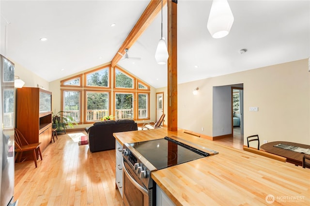 324 Gill Ln, Friday Harbor, WA 98250 - kitchen featuring open floor plan, stainless steel range with electric stovetop, butcher block counters, light wood-style floors, and vaulted ceiling with beams