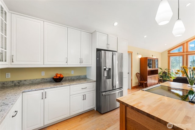 324 Gill Ln, Friday Harbor, WA 98250 - kitchen with stainless steel fridge, recessed lighting, glass insert cabinets, butcher block counters, and light wood-style floors