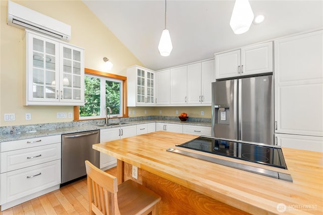 324 Gill Ln, Friday Harbor, WA 98250 - kitchen with a wall unit AC, a sink, lofted ceiling, stainless steel appliances, and wood counters