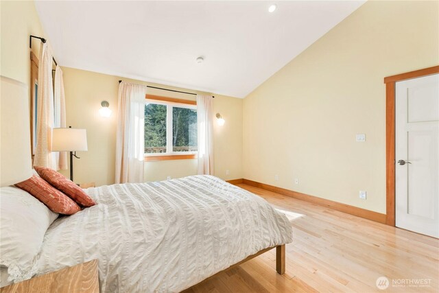 324 Gill Ln, Friday Harbor, WA 98250 - bedroom with wood finished floors, baseboards, and vaulted ceiling