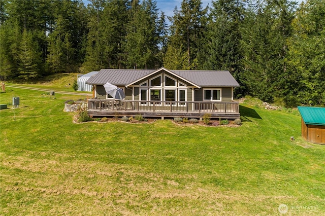 324 Gill Ln, Friday Harbor, WA 98250 - rear view of property featuring a wooden deck, metal roof, and a lawn