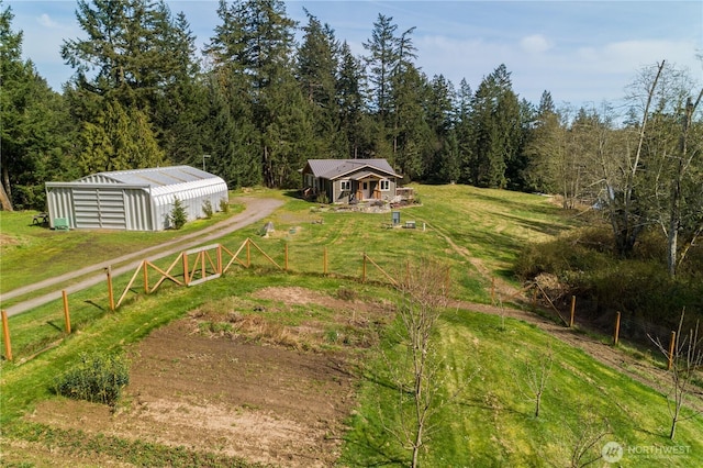 324 Gill Ln, Friday Harbor, WA 98250 - exterior space with a forest view, an outdoor structure, fence, and an outbuilding