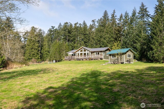324 Gill Ln, Friday Harbor, WA 98250 - exterior space featuring a wooded view, a yard, metal roof, and a wooden deck