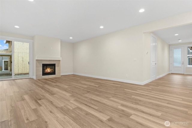 19457 116th St E, Bonney Lake, WA 98391 - unfurnished living room featuring a tile fireplace, light wood-type flooring, baseboards, and recessed lighting