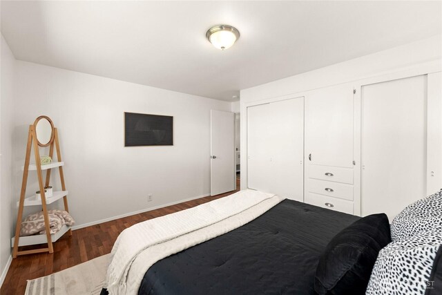 14207 6th Ave S, Burien, WA 98168 - bedroom featuring a closet, baseboards, and dark wood-style floors