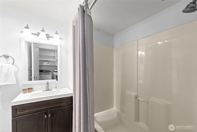 14207 6th Ave S, Burien, WA 98168 - bathroom featuring washer and dryer, a shower with curtain, and vanity