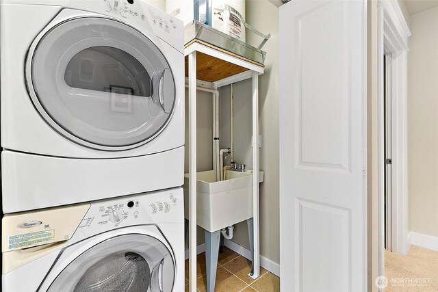 708 Market St Unit 711, Tacoma, WA 98402 - laundry area with tile patterned floors, baseboards, laundry area, and stacked washer / drying machine