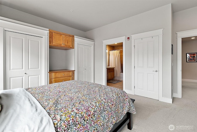 708 Market St Unit 711, Tacoma, WA 98402 - bedroom with baseboards, multiple closets, connected bathroom, and light carpet