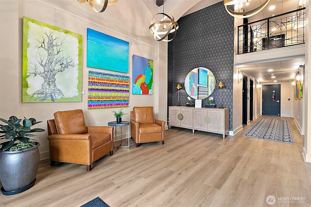 708 Market St Unit 711, Tacoma, WA 98402 - sitting room with a high ceiling, baseboards, an accent wall, and wood finished floors
