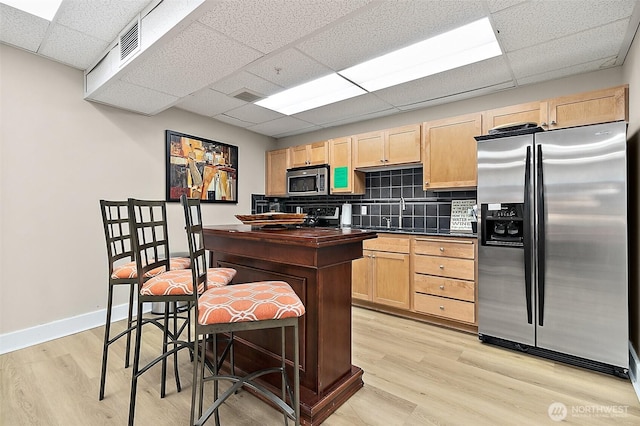 708 Market St Unit 711, Tacoma, WA 98402 - kitchen with light brown cabinets, light wood-style flooring, visible vents, and stainless steel appliances