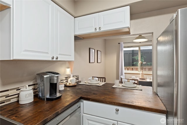 18200 73rd Ave NE Unit B103, Kenmore, WA 98028 - kitchen with white cabinets, butcher block countertops, appliances with stainless steel finishes, and a peninsula