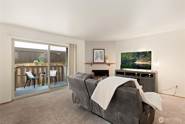 18200 73rd Ave NE Unit B103, Kenmore, WA 98028 - living room featuring a tiled fireplace, carpet, and baseboards
