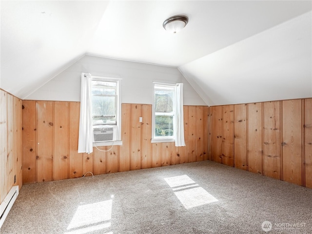 additional living space with carpet, wooden walls, a baseboard radiator, lofted ceiling, and cooling unit