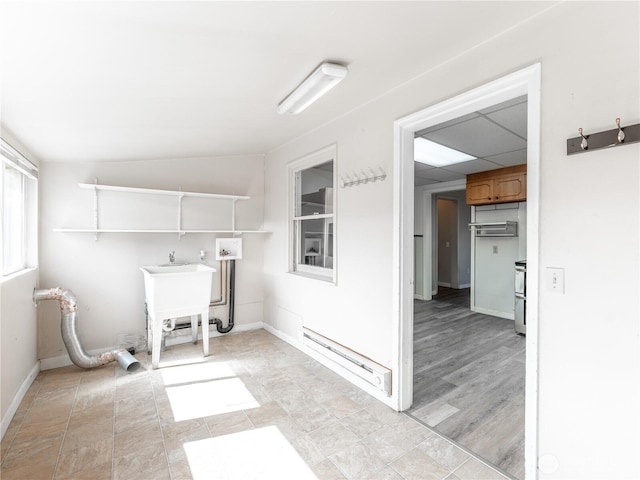 laundry area with a baseboard radiator, laundry area, baseboards, and hookup for a washing machine