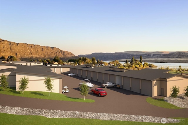 exterior space with a water and mountain view