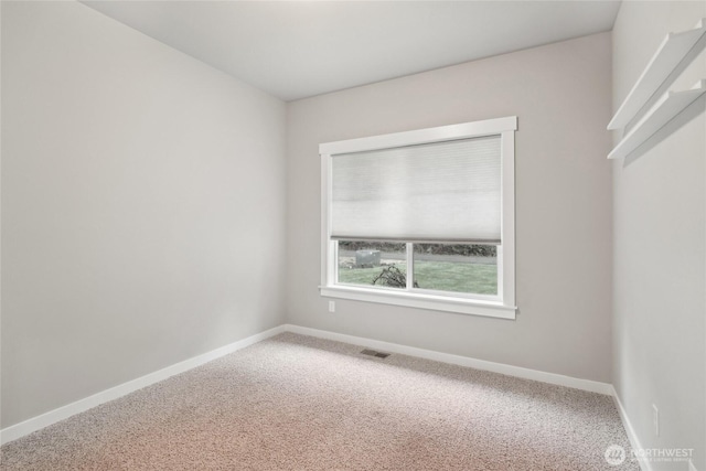 carpeted empty room with baseboards and visible vents