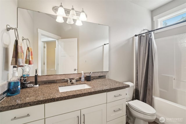 bathroom featuring toilet, vanity, and shower / bath combo with shower curtain