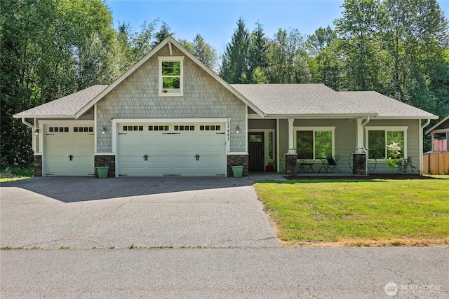 21401 127th Ave NE, Arlington, WA 98223 - craftsman-style house with driveway, a front lawn, a garage, and roof with shingles