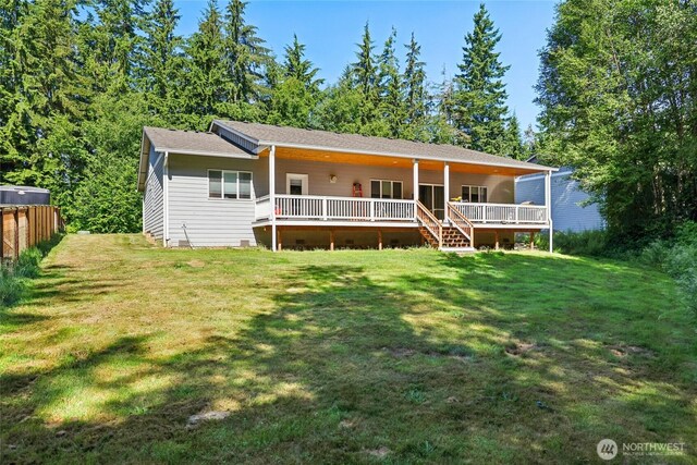 21401 127th Ave NE, Arlington, WA 98223 - rear view of house featuring a wooden deck and a lawn