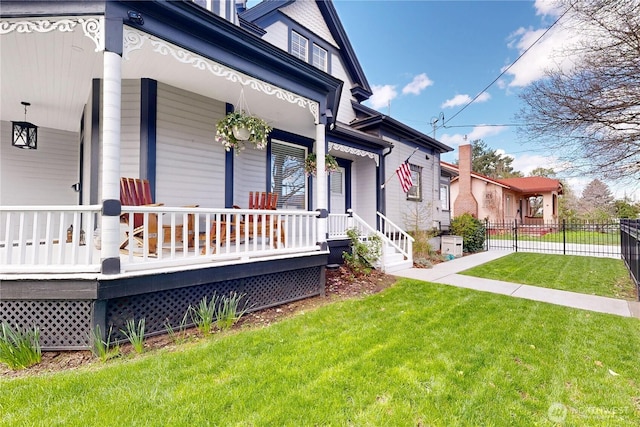 view of property exterior featuring a yard, fence, and covered porch