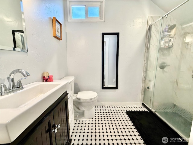 full bathroom featuring a shower stall, tile patterned floors, vanity, and toilet