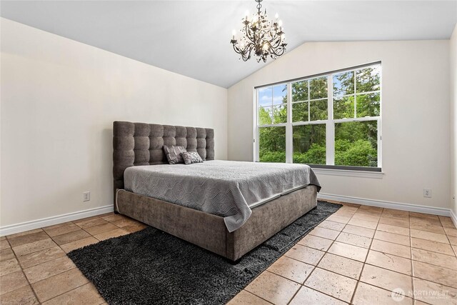 bedroom featuring a chandelier, lofted ceiling, and baseboards