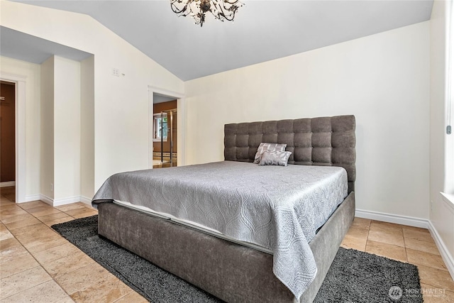 bedroom featuring lofted ceiling, baseboards, and a chandelier