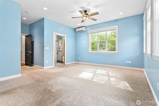 unfurnished bedroom with a wall mounted air conditioner, carpet, baseboards, recessed lighting, and ensuite bathroom