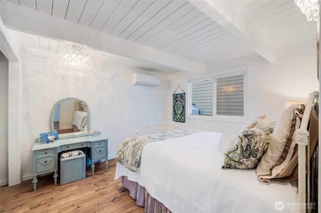 bedroom featuring an AC wall unit, beam ceiling, and a chandelier