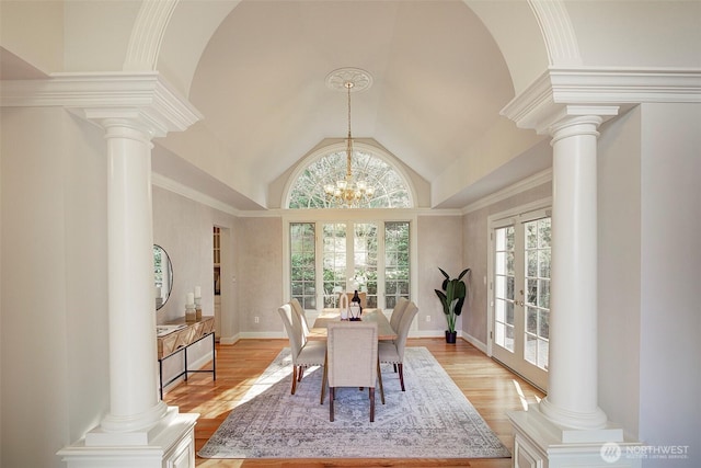 dining space with french doors, decorative columns, and a healthy amount of sunlight