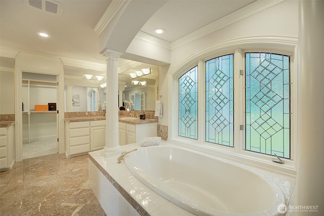 full bathroom with vanity, ornamental molding, a bath, visible vents, and decorative columns