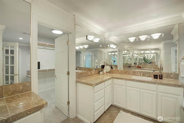 full bath with crown molding, visible vents, a spacious closet, and vanity