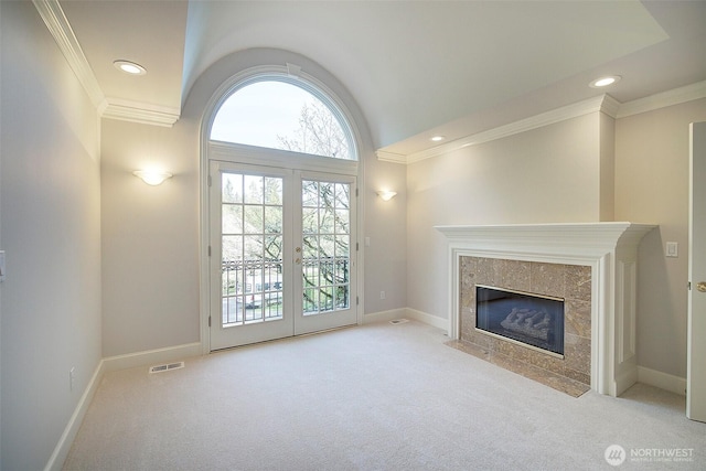 unfurnished living room featuring crown molding, baseboards, and carpet flooring