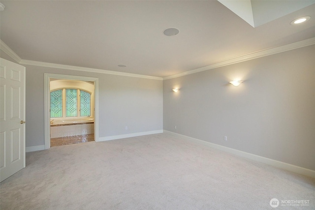 spare room featuring light carpet, baseboards, ornamental molding, and recessed lighting