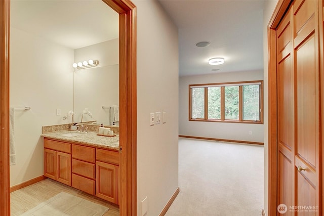 bathroom featuring vanity and baseboards