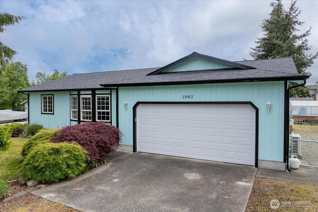 1903 Elhardt Dr, Camano Island, WA 98282 - ranch-style home featuring driveway, a garage, roof with shingles, and fence