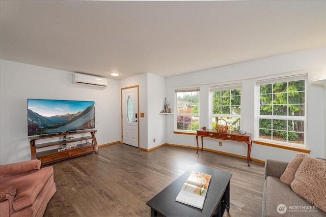 1903 Elhardt Dr, Camano Island, WA 98282 - living room featuring an AC wall unit, wood finished floors, and baseboards