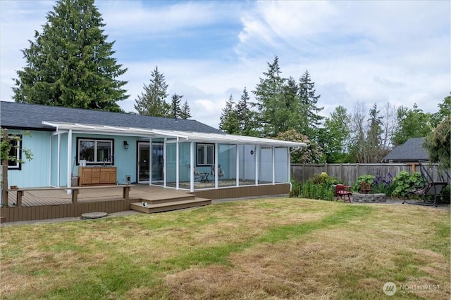 1903 Elhardt Dr, Camano Island, WA 98282 - rear view of house with a deck, a fire pit, and a sunroom