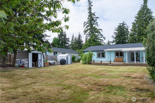 1903 Elhardt Dr, Camano Island, WA 98282 - view of yard featuring a storage unit, an outbuilding, and a wooden deck