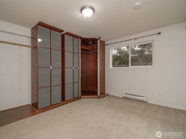 14527 NE 40th St Unit G204, Bellevue, WA 98007 - unfurnished bedroom featuring a baseboard heating unit and carpet