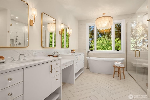 full bath with a soaking tub, vanity, and a shower stall