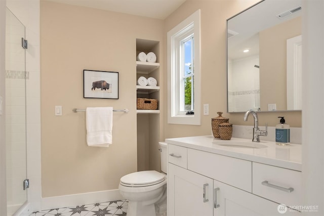 full bath featuring visible vents, baseboards, toilet, vanity, and a stall shower